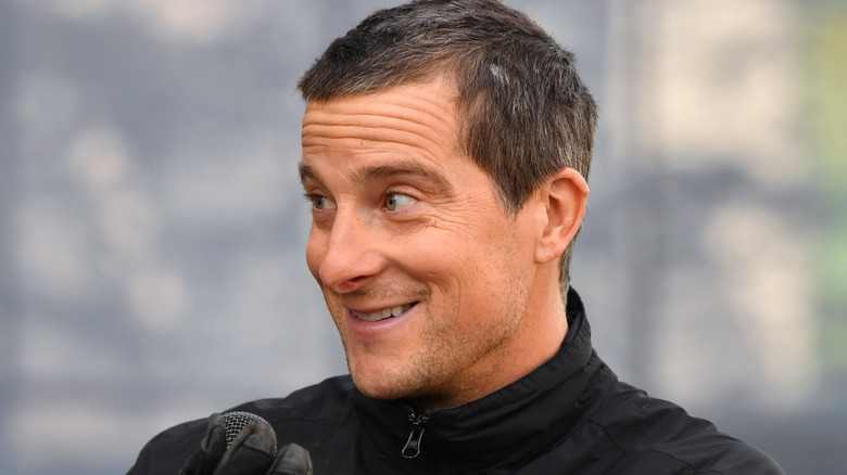 bear grylls smiling by trees